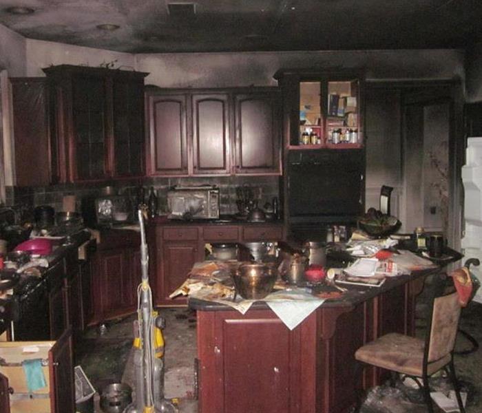 a kitchen with smoke and fire damage