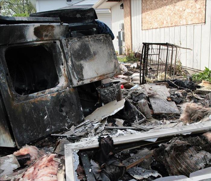 burned vehicle, boarded up house