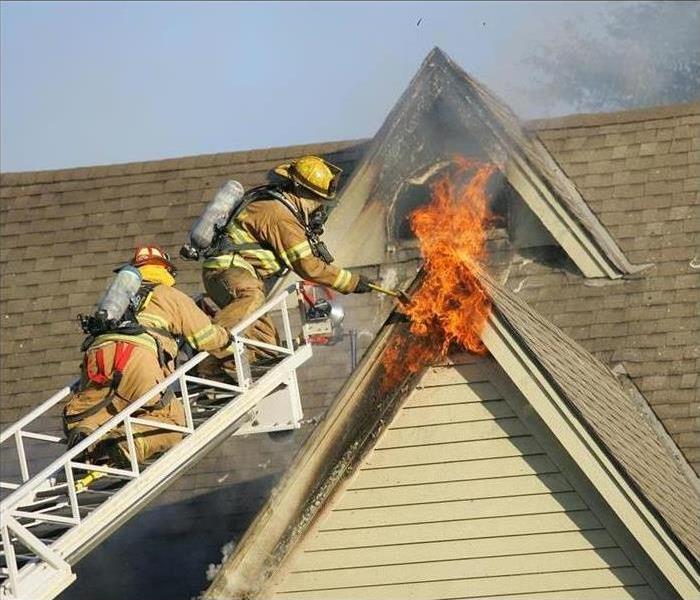 Fire Fighters Putting out Roof Flame